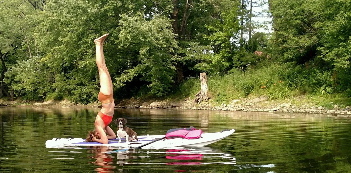 "Lucy cheering me on during headstand! She loves paddling up and down the creek. :)" by Kristen Shay