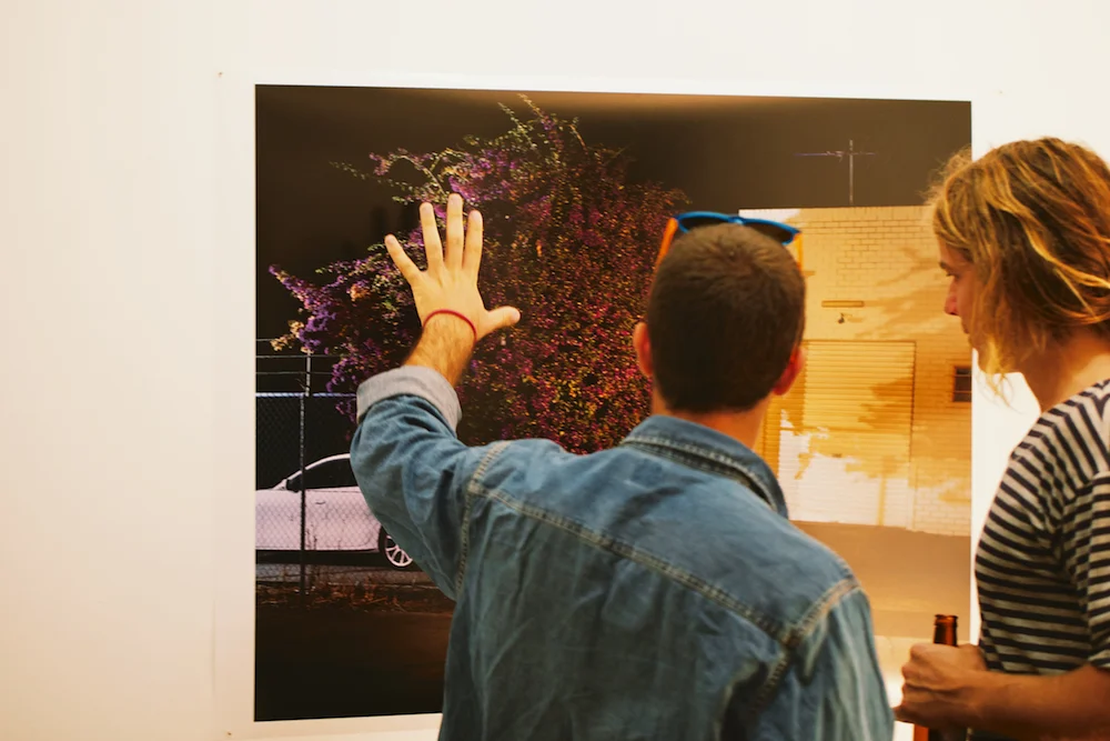 Audience members viewing photographic work by Nigel Bennet, 2014