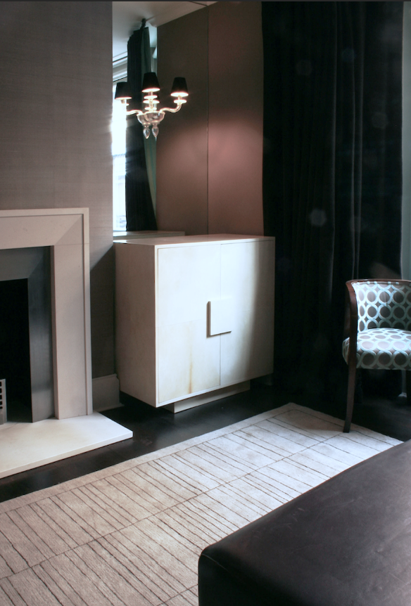 Bespoke parchment TV cabinet, against antiqued mirror and Murano glass wall lights with chocolate suede shades