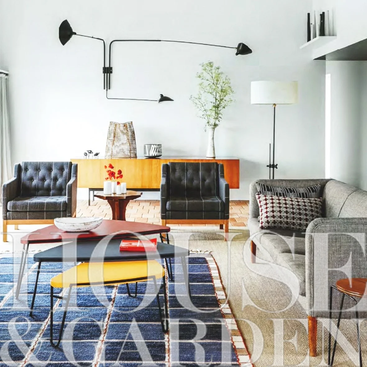 Sitting room, with Mid-Century Scandinavian furnishings, vintage Swedish rug, Serge Mouille wall light, client’s collection of ceramics
