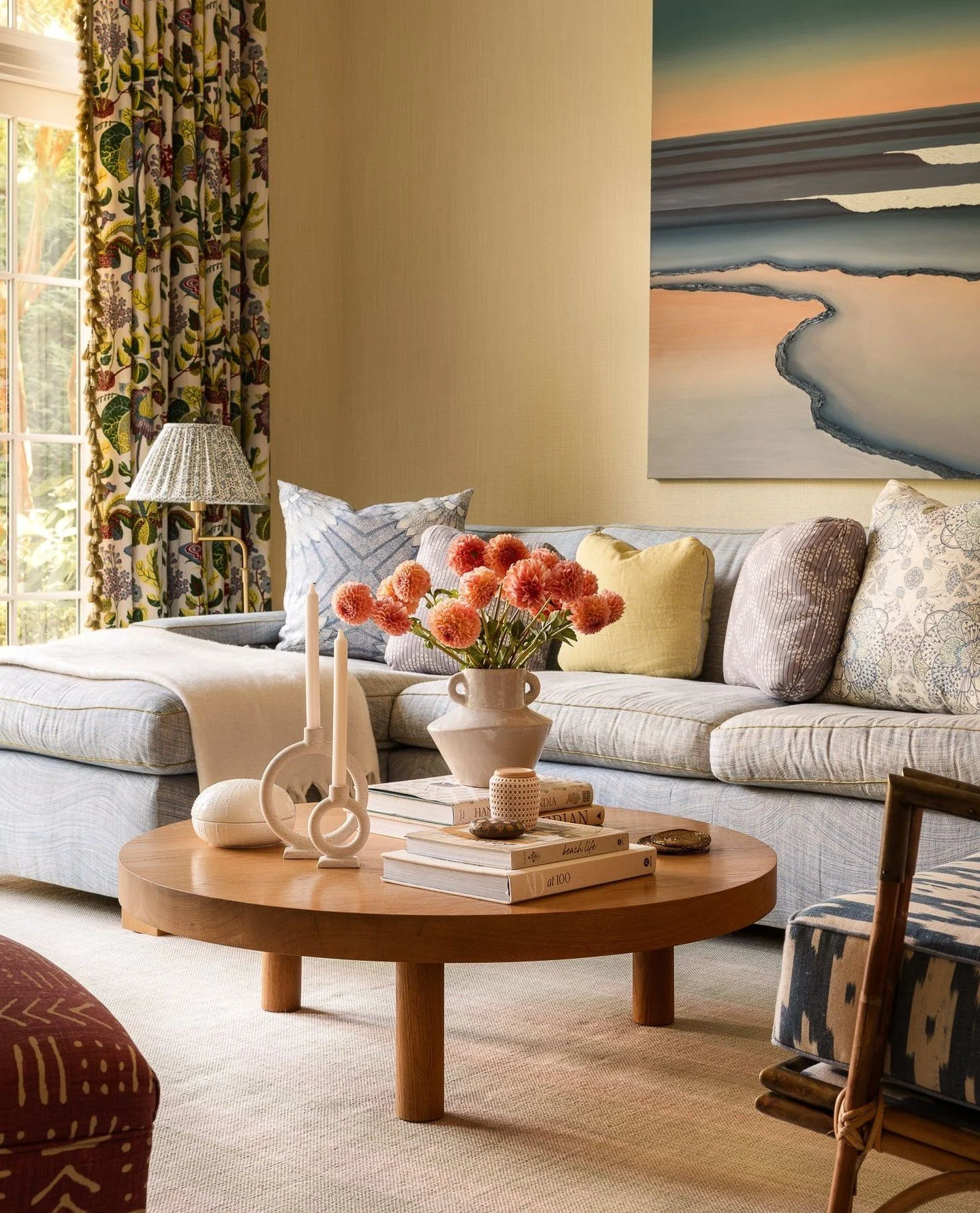 Morning light from the northeast washes softly across the living room, bringing warmth to the layered textures and playful patterns. Styled and decorated by Sara Gilbane, the space captures an easy elegance&mdash;comfortable, refined, and connected t