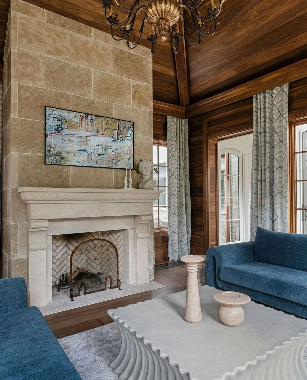 Warm walnut paneling, a carved limestone fireplace, and sculptural furnishings create a living space rooted in craftsmanship and quiet luxury. Every material brings depth, character, and a sense of timeless ease.⁠
⁠
Designer: @donidouglas_design⁠
Arc
