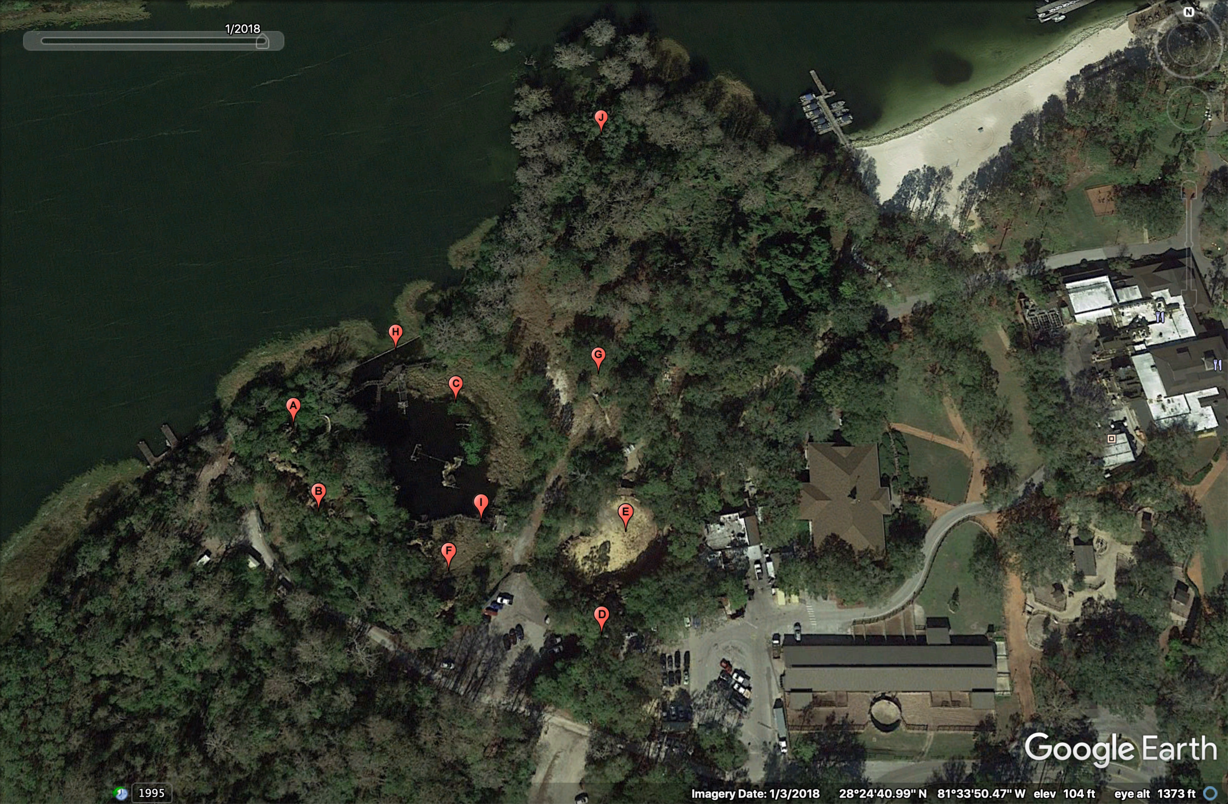 Aerial view of River Country in January 2018. As you can see, vegetation has practically taken over the whole property. Red pins represent each of the park’s attractions. A) Whoop ‘n Holler Hollow; B) White Water Rapids; C) Bay Cove Pool; D) Slippery Slide Falls; E) Upspring Plunge; F) Kiddie Kove; G) Indian Springs; H) Bay Bridge; I) Barrel Bridge; J) Cypress Point Nature Trail (Photo: Google Earth, labeling by me)