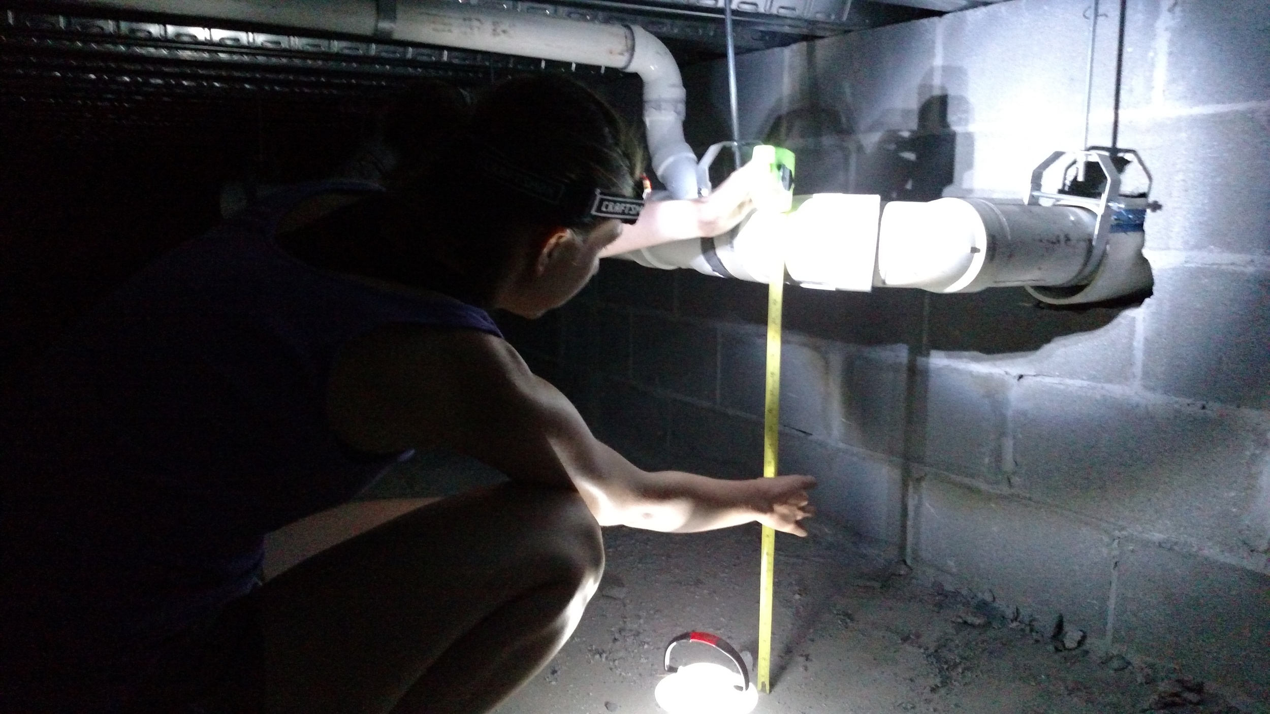 Measuring under the floor to make sure we will have enough slope for our hand sink. (Yeah, we learned a lot of things we never thought we would know in this process!)