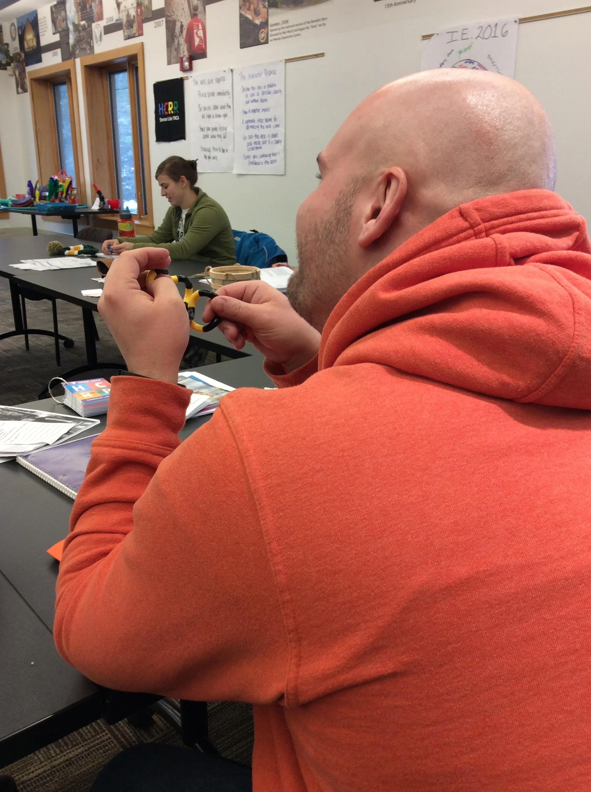 Fidgeting and listening at Sherman Lake YMCA's spring staff training. Photo by Karen Christopherson.