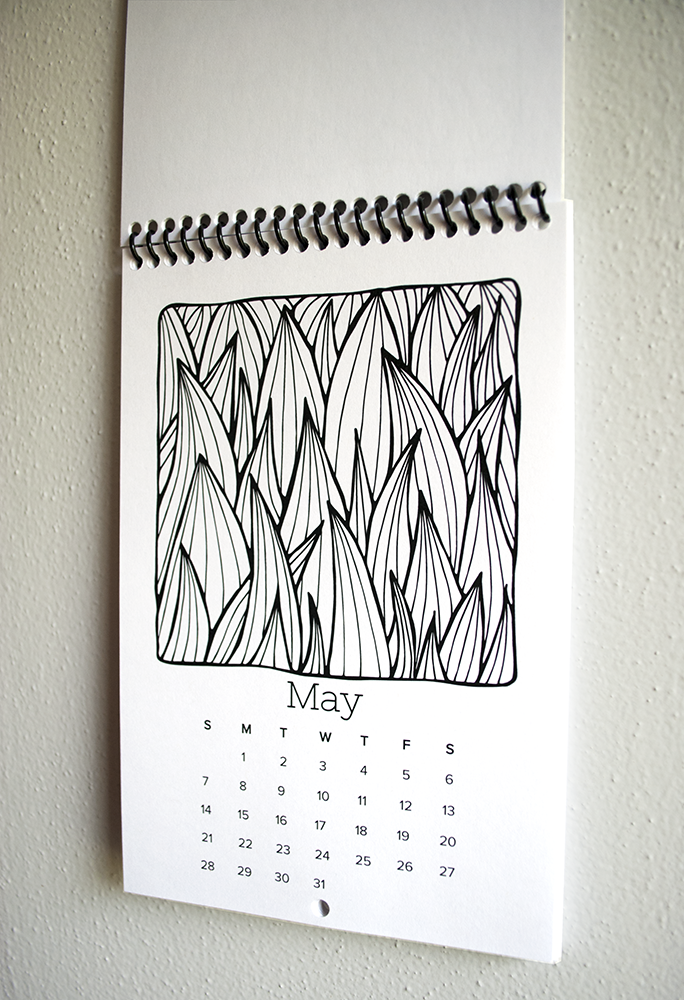 The spiral bound calendar comes with a small hole in each page so it's easy to hang.