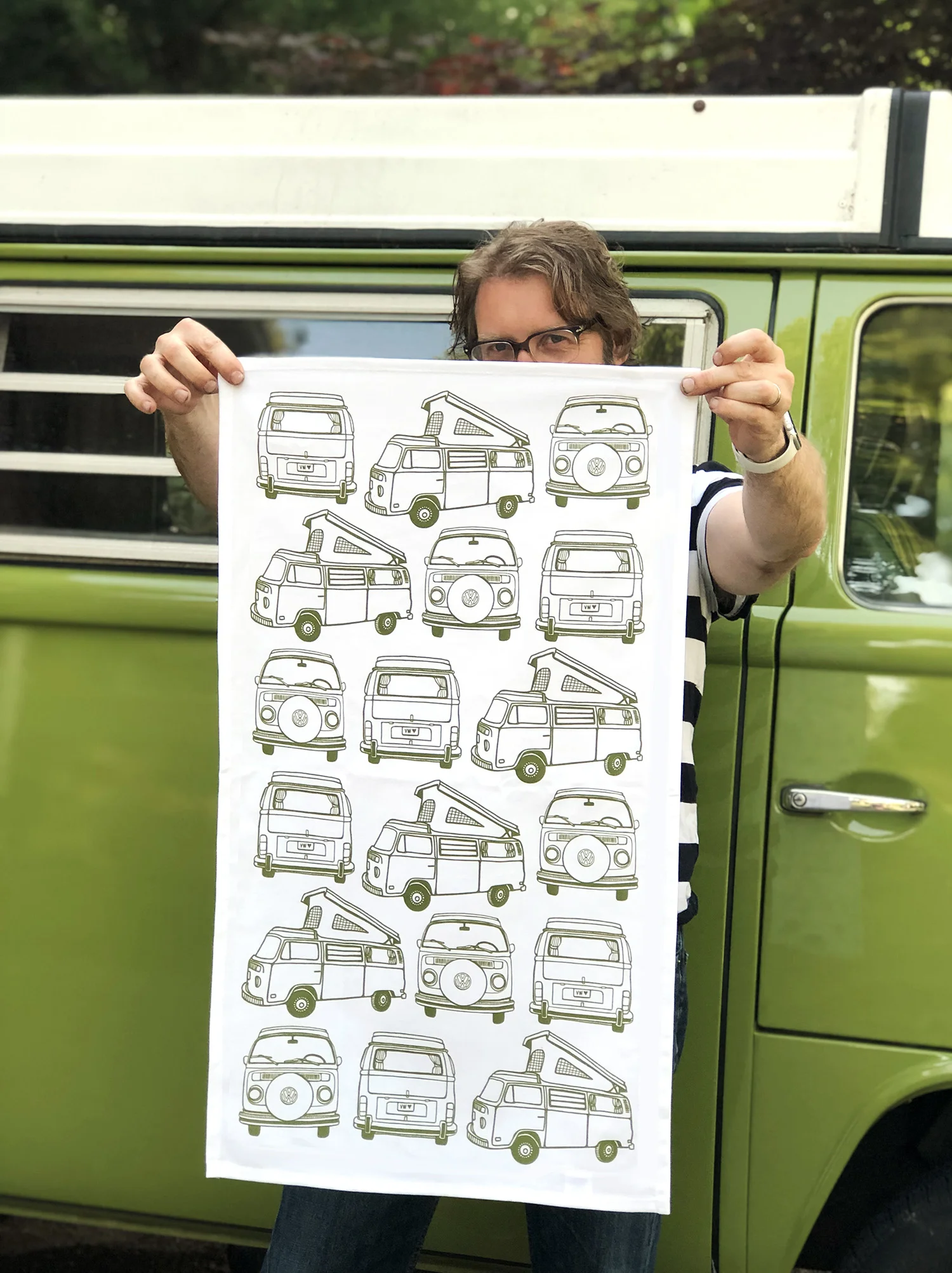 My husband modeling my new VW Bus tea towel in front of the bus that inspired it.