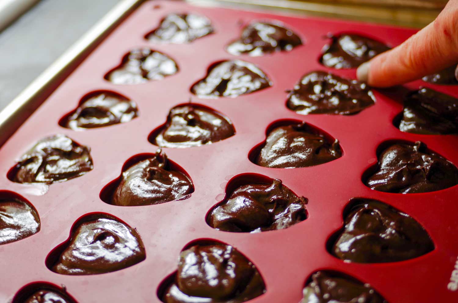 Cleaning the candy mold.