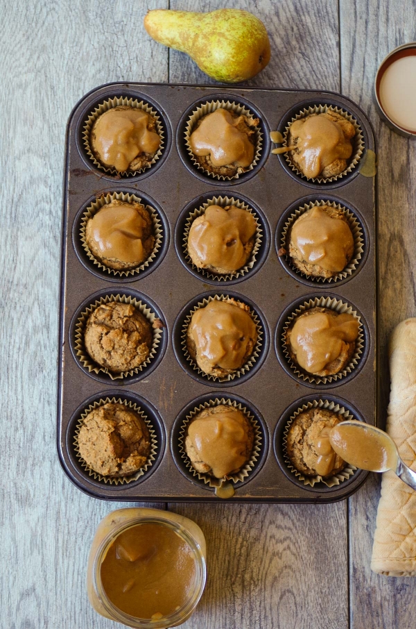 Silky Salted Caramel Sauce drizzled over Pear Spice Muffins.