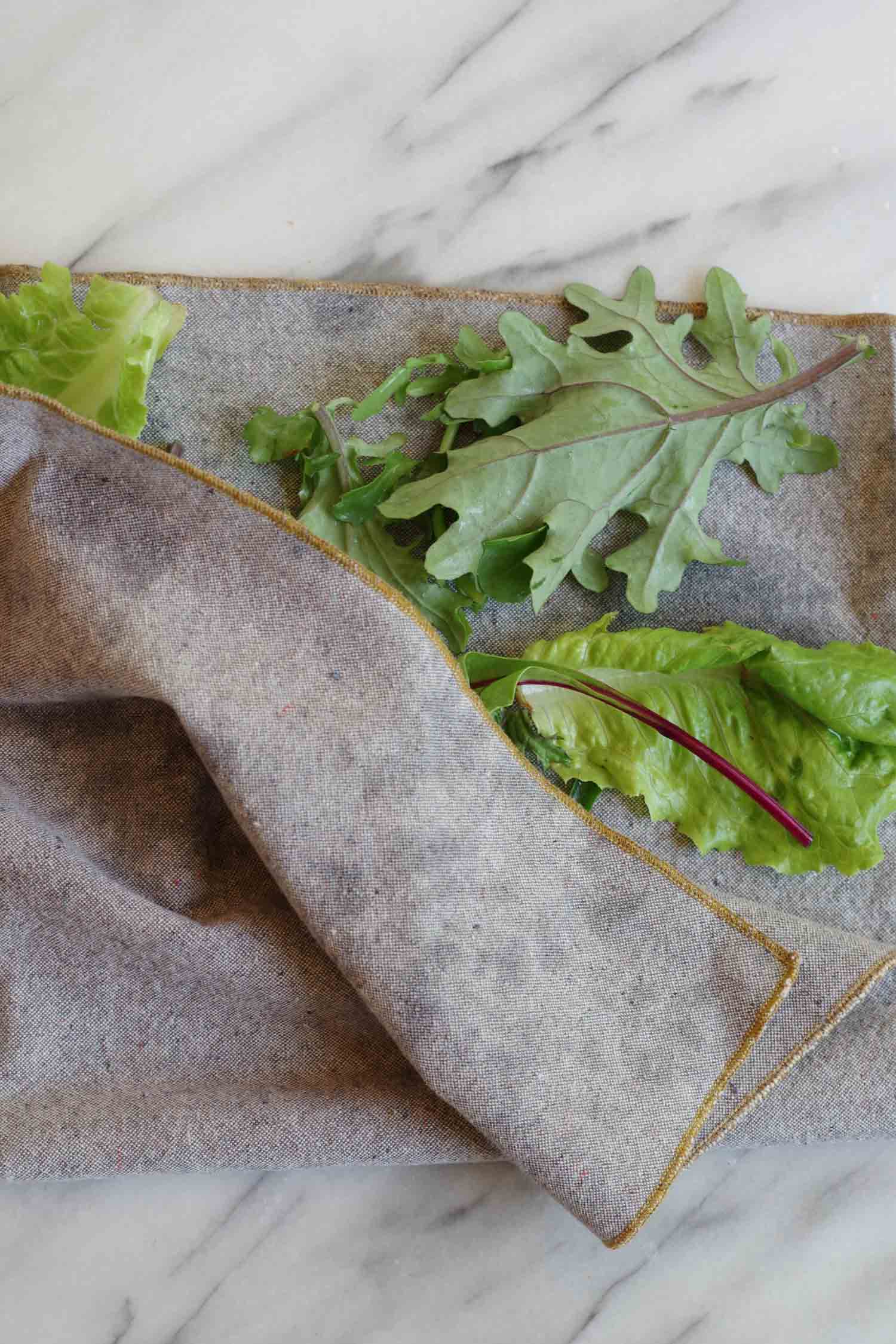 Patting greens dry with an organic cotton/hemp Heathered Napkin from the shop, by Beautiful Ingredient