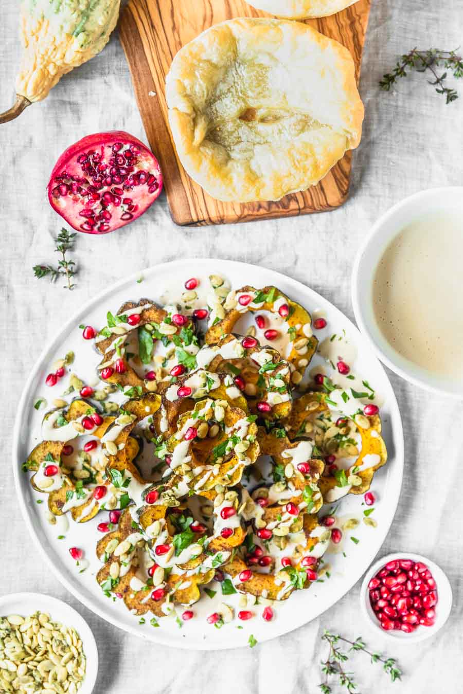 Garam Masala Roasted Acorn Squash recipe from The Ultimate Vegan Cookbook, Photo by Kari of Beautiful Ingredient. #vegan #gluten-free #thanksgiving #holiday #squash #pomegranate #tahini