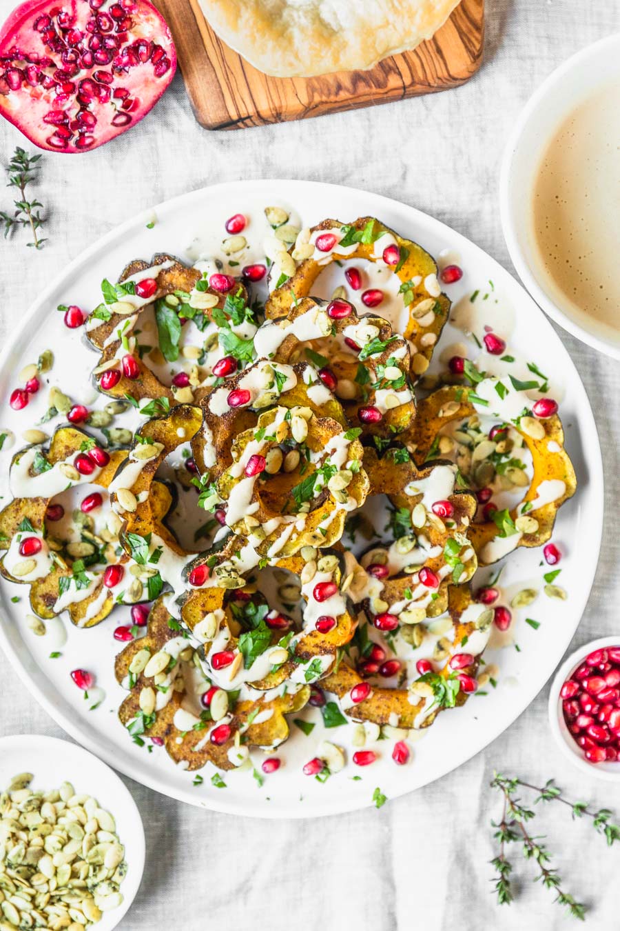 Garam Masala Roasted Acorn Squash recipe from The Ultimate Vegan Cookbook, Photo by Kari of Beautiful Ingredient. #vegan #gluten-free #thanksgiving #holiday #squash #pomegranate #tahini