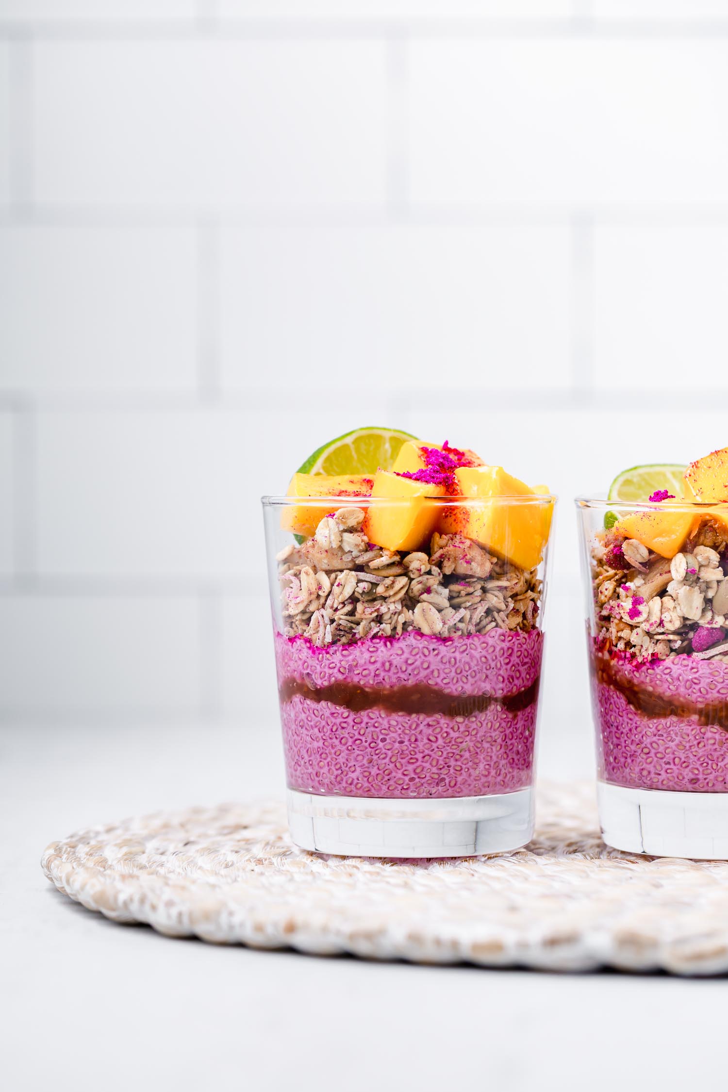 Tropical Dragon Fruit Chia Pudding Breakfast Bowls or Parfaits, so easy to make, colorful, and a real summer treat! #chiapudding #chiapuddingparfait #breakfastbowl #breakfast #vegan #veganbreakfast #veganrecipe #tropicalrecipe #tropicalveganrecipe #summerrecipe #dragonfruit #pitaya #tropicalbowl