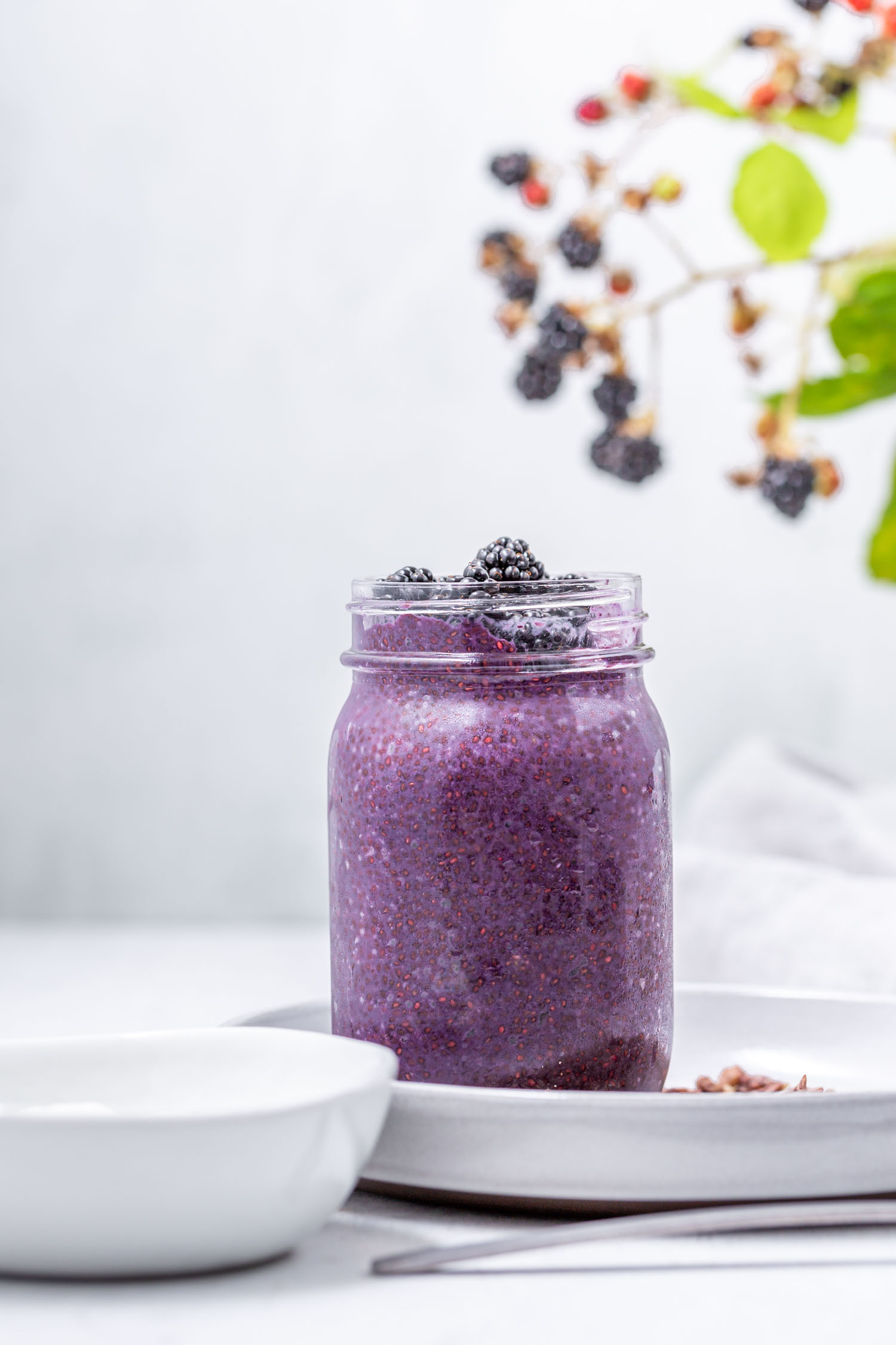 This Blackberry Chia Pudding recipe is vegan, quick, easy, gluten-free, refined sugar-free, and grain-free, requires 10 ingredients or less, only 15 minutes or less time in the kitchen, is a seasonal summer recipe that can be made year-round with frozen berries, and makes a great breakfast, snack, or dessert. #chiapudding #blackberry #vegan #breakfast