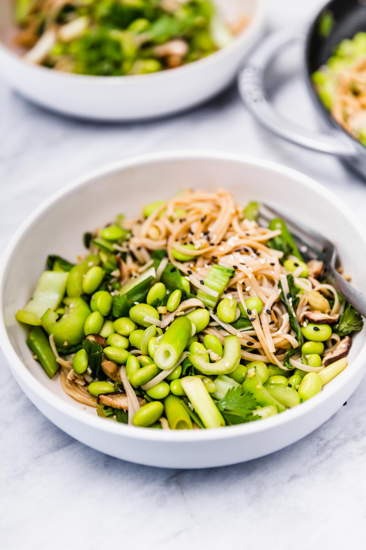 Edamame and Bok Choy Sauté with Rice Noodles and Miso Lime Sauce    is plant-based, quick (ready within 30 minutes from chopping to plating), easy, gluten-free, oil-free, nut-free, veggie-packed (with three servings of veg per person - including one cruciferous), satisfying (with a serving of beans per person), and great all year round, especially during the fall/winter seasons. #vegandinner #ricenoodles #misosauce #wfpb #dinner #plantbased #edamame #bokchoy