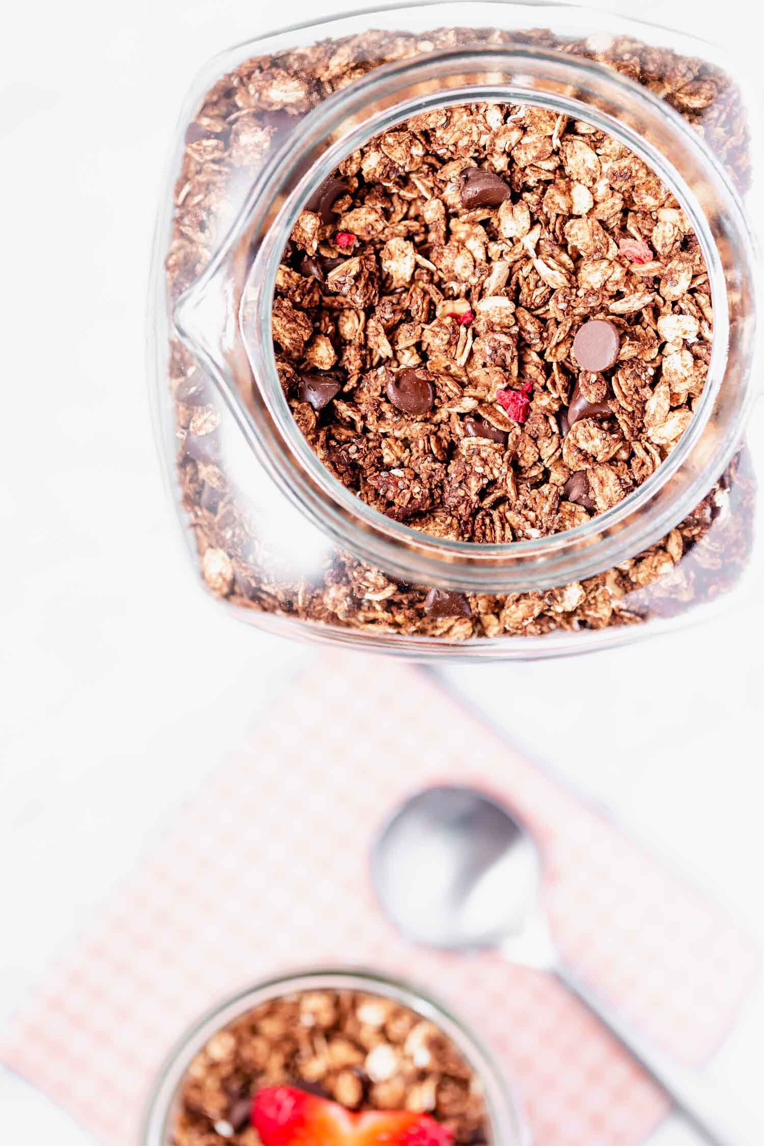 Chocolate and freeze-dried berries are the perfect combo in this crispy granola, inspired by store-bought granola. Vegan, gluten-free, oil-free, sugar-free (optional), easy, with minimal prep time, yet makes a big batch. #granola #granolarecipe #vegangranola #oilfreevegan #sugarfree #vegangranolarecipe #veganbreakfast #quickbreakfast #quicksnack #vegansnack #breakfastideas #breakfastideashealthy #breakfastrecipes #glutenfreerecipes