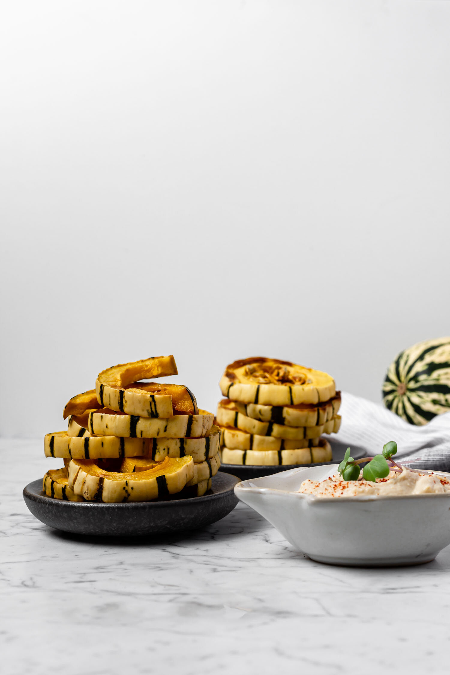Delicata Dippers, a one-ingredient satisfying snack that takes just 5 minutes to prepare, are cooked and ready to eat within 25 minutes, and taste wonderful dipped in hummus or another savory dip. While a carrot or celery stick might not replace chips or crackers easily, these will! They’re filling and great for weight loss. #delicata #squash #weightloss #snack #weightlosssnacks #easyrecipe #oneingredientrecipe #readyin30minutes #wholefoodsnack #chipreplacement #crackerreplacement