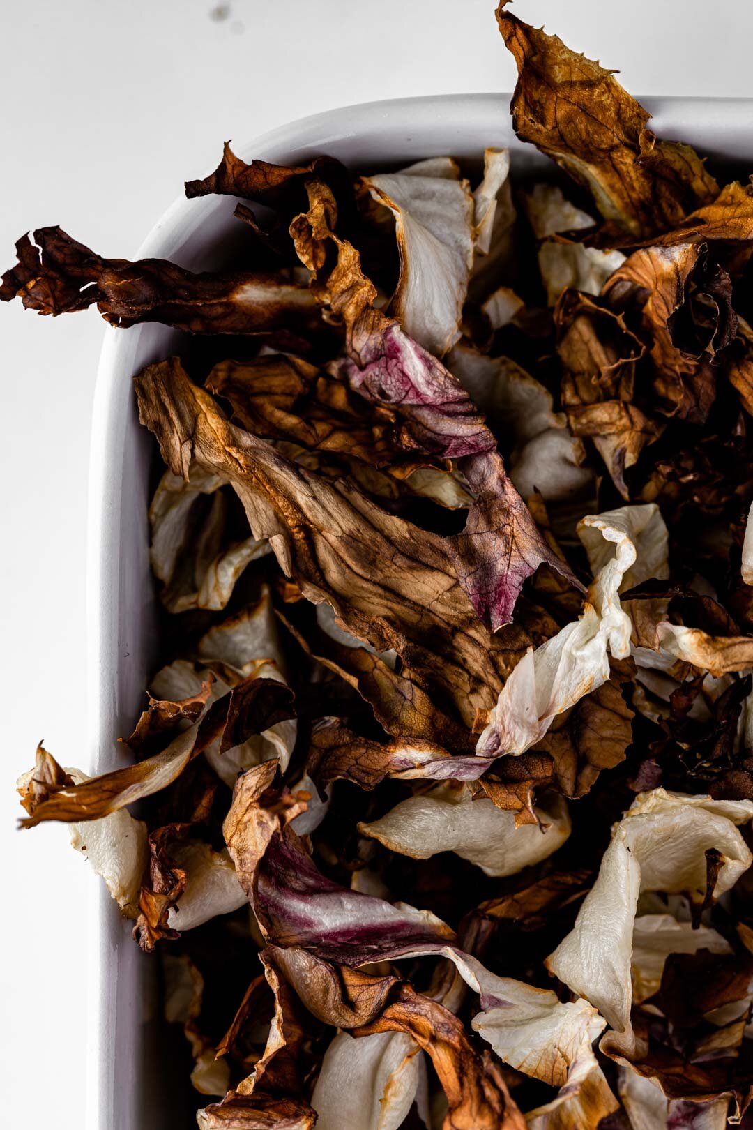 Crispy Roasted Radicchio Strips Recipe, Oil-Free Vegan by Beautiful Ingredient. Ready within 10 minutes in your air fryer! Crispy and bittersweet, these make a great snack or topping. #radicchio #oilfree #oilfreeveganrecipes #radicchiorecipes #roastedveggies #roastedvegetables #airfryer #vegan #plantbased #oneingredientrecipes #winterrecipes #autumnrecipes #fallrecipes