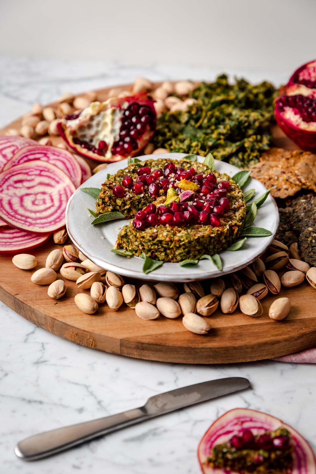 Arugula Pecan Vegan Cheesy Spread is an appetizer that satisfies that cheese craving with just six whole-food ingredients - and it’s quick and easy, ready in just 15 minutes! A perfect addition to your next cheese board. Recipe by Kari of Beautiful Ingredient #vegancheeseboard #cheeseballrecipes #vegancheeseball #vegancheesespread #vegancheese #veganrecipes #veganholidayappetizers #veganholidayrecipes #appetizers
