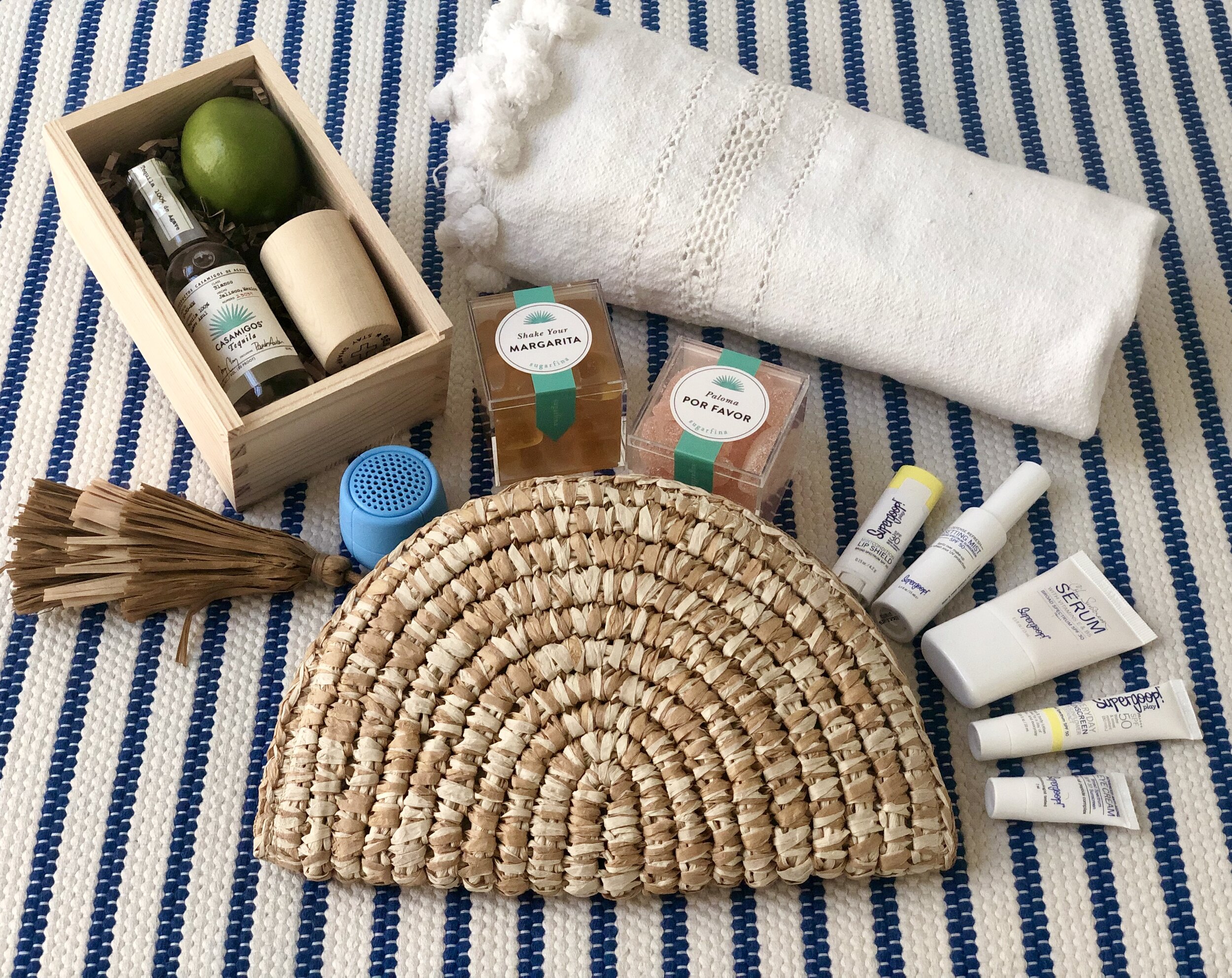 Clutch (similar here ) , Casamigos Tequila, Wooden Box + Best Made Shot Glass , Sugarfina + Casamigos 3pc Bento Box , Supergoop! Hello Sunshine! Starter Kit , Turkish Towel (similar here ) , Lexon Mino x Waterproof Speaker