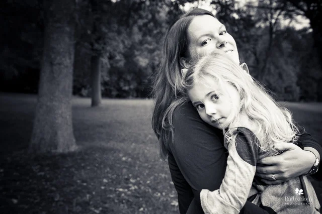 mom holding daughter