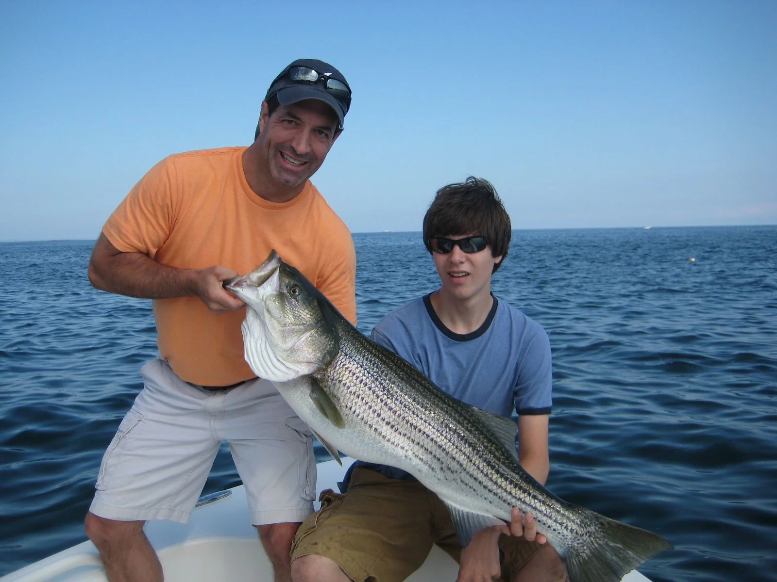 Image of a large striped bass caught by father and son off Boston