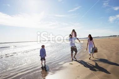 stock-photo-33175736-rear-view-of-family-walking-along-beach-with-picnic-basket.jpg