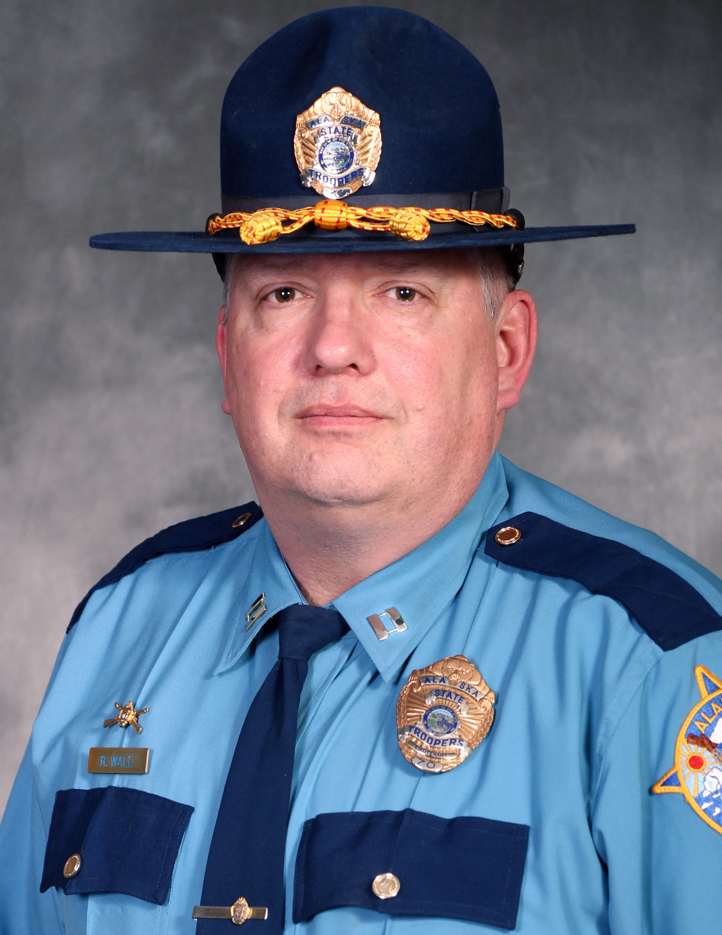 Captain Ron Wall Peer Recognition Award Alaska State Troopers Captain Ron Wall has been recognized by his peers for the outstanding work he has put into our community. Captain Wall started the Rescue Task Force concept that is set up to deal with an active shooter in the borough. With his leadership he was able to bring both Police and EMS together to deal with this type of emergency, which is not an easy thing to do. By building this task force he has made our community a safer place for everyone. Captain Wall has been captain in his detachment for just over a year now, but has worked with the Troopers for years prior. Wall is an executive board member for the North Star Youth Court, part of the Peace Officers Association, and is a member of the UAF Alumni Association. He has started numerous programs to help move the community in the right direction (including Project Life Saver, Impact Teen Driving, and Mass Casualty and Response Program). He says that, “you either move forward in this world, or you move backwards.” One thing he loves about his work is that you can meet people under tragic and horrific circumstances and still have the ability to be a positive influence on that individual’s life.