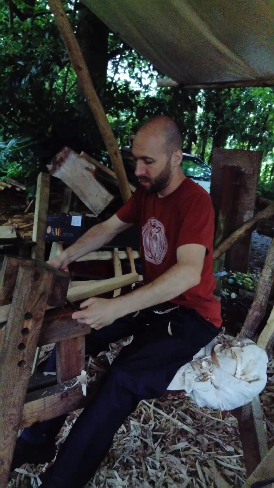 Dan Slee shaping a stool leg on the shave horse while the sun was still up