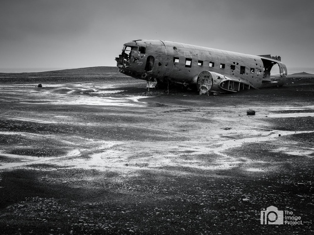 abandoned douglas r4d-8 airplane on beach vedur south iceland during rain by nathan barry the image project