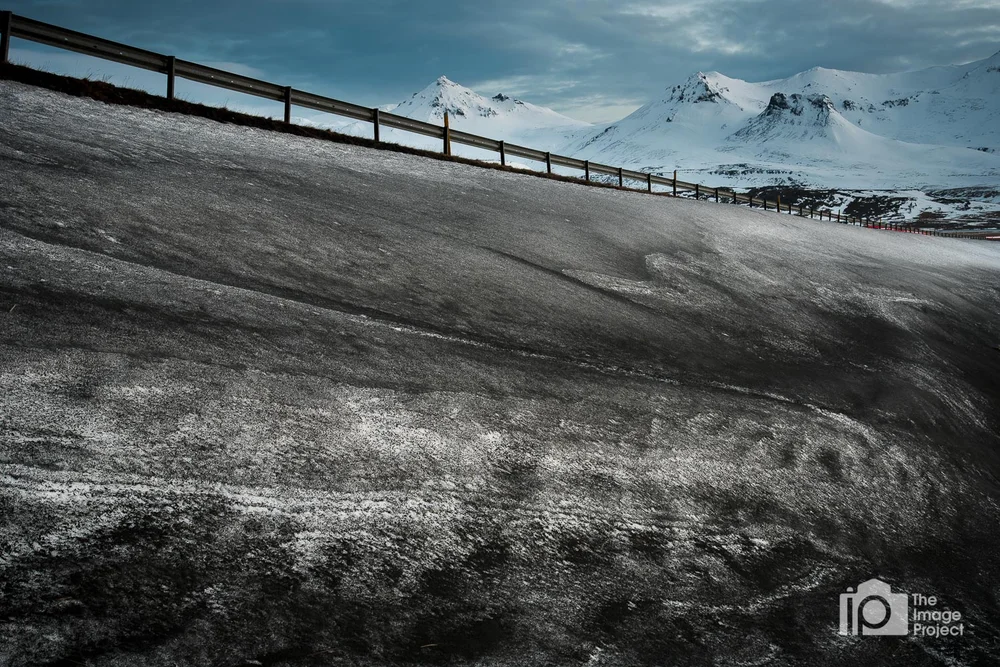 ice patterns in black sand below mountain peaks in snæfellsnes peninsula iceland by nathan barry the image project