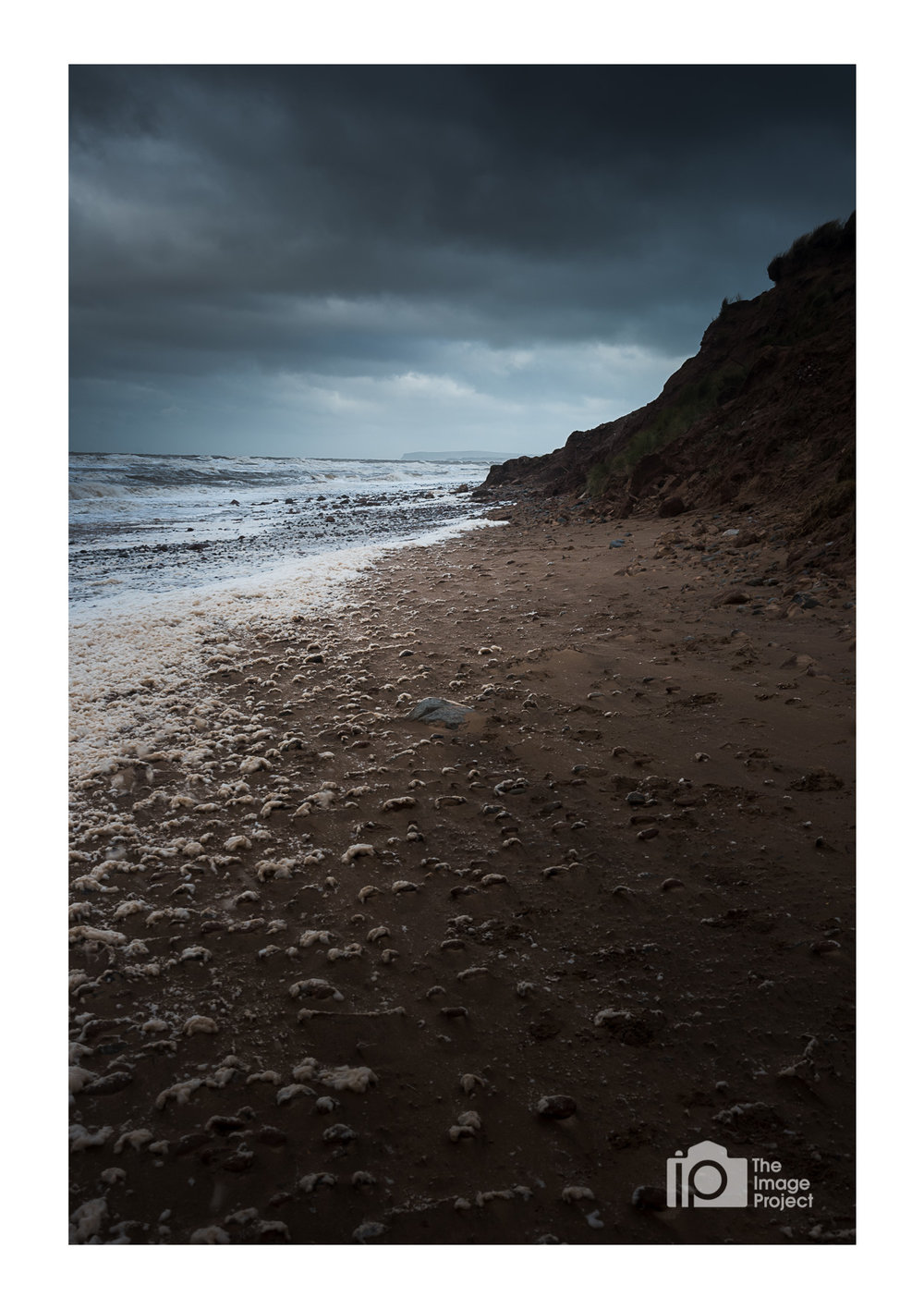 Moody skies on a frothy beach, Drigg