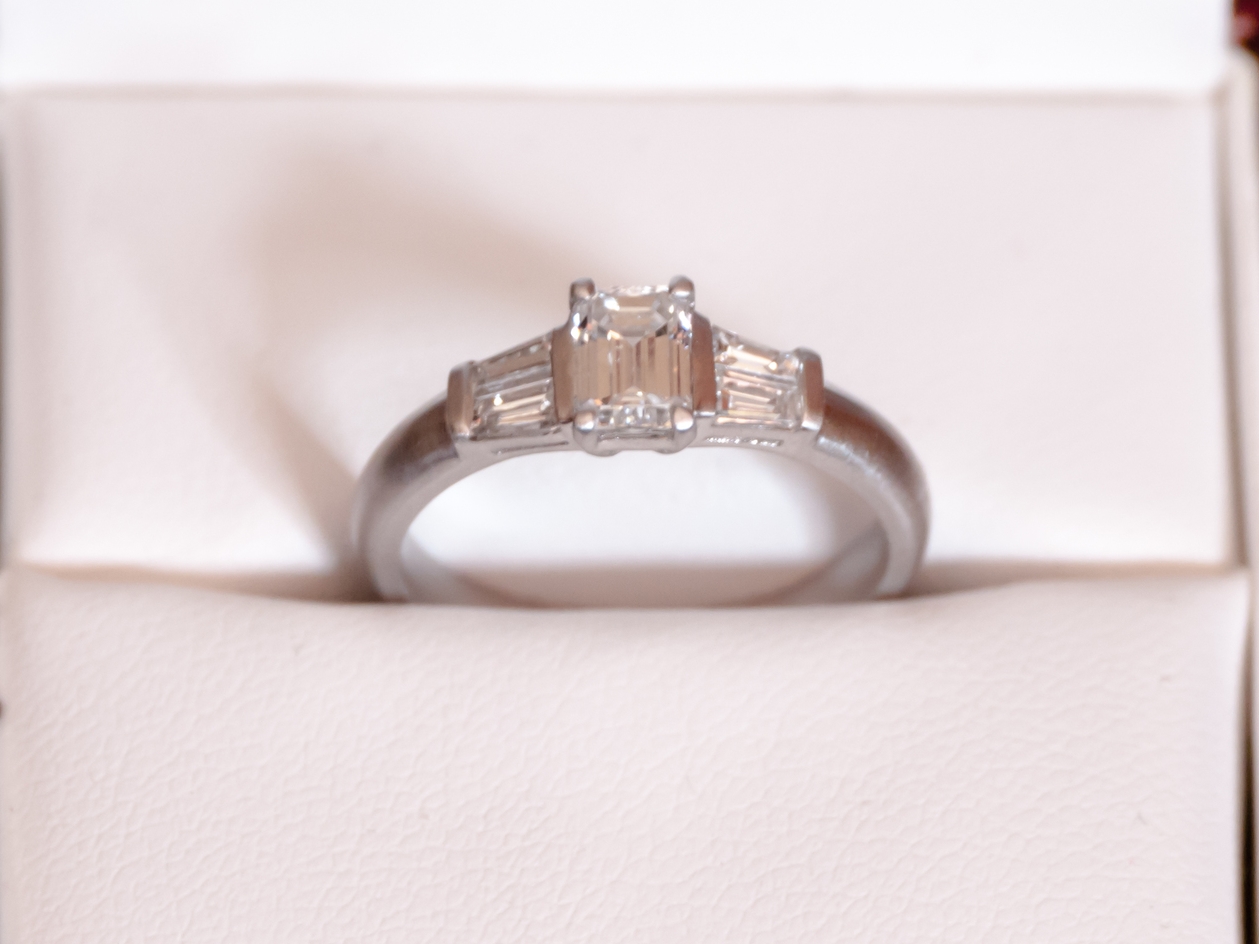 Emerald cut diamond with tapered heirloom baguettes in a 3D printed Art Deco setting
