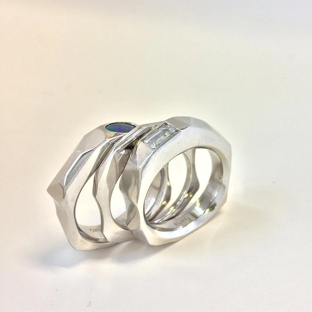Custom stacking platinum bands with emerald cut diamond and Australian opal