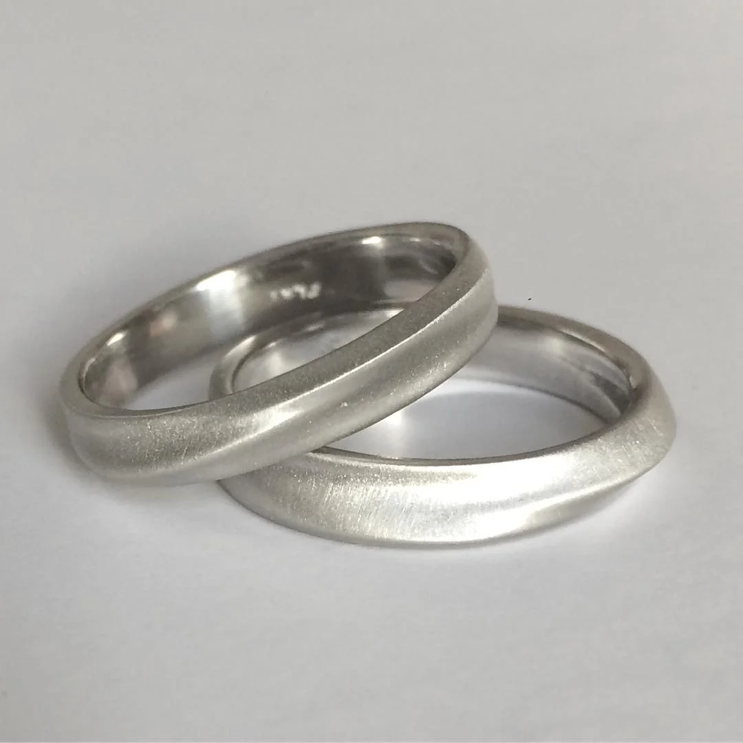 Pair of custom 3D printed platinum wedding bands