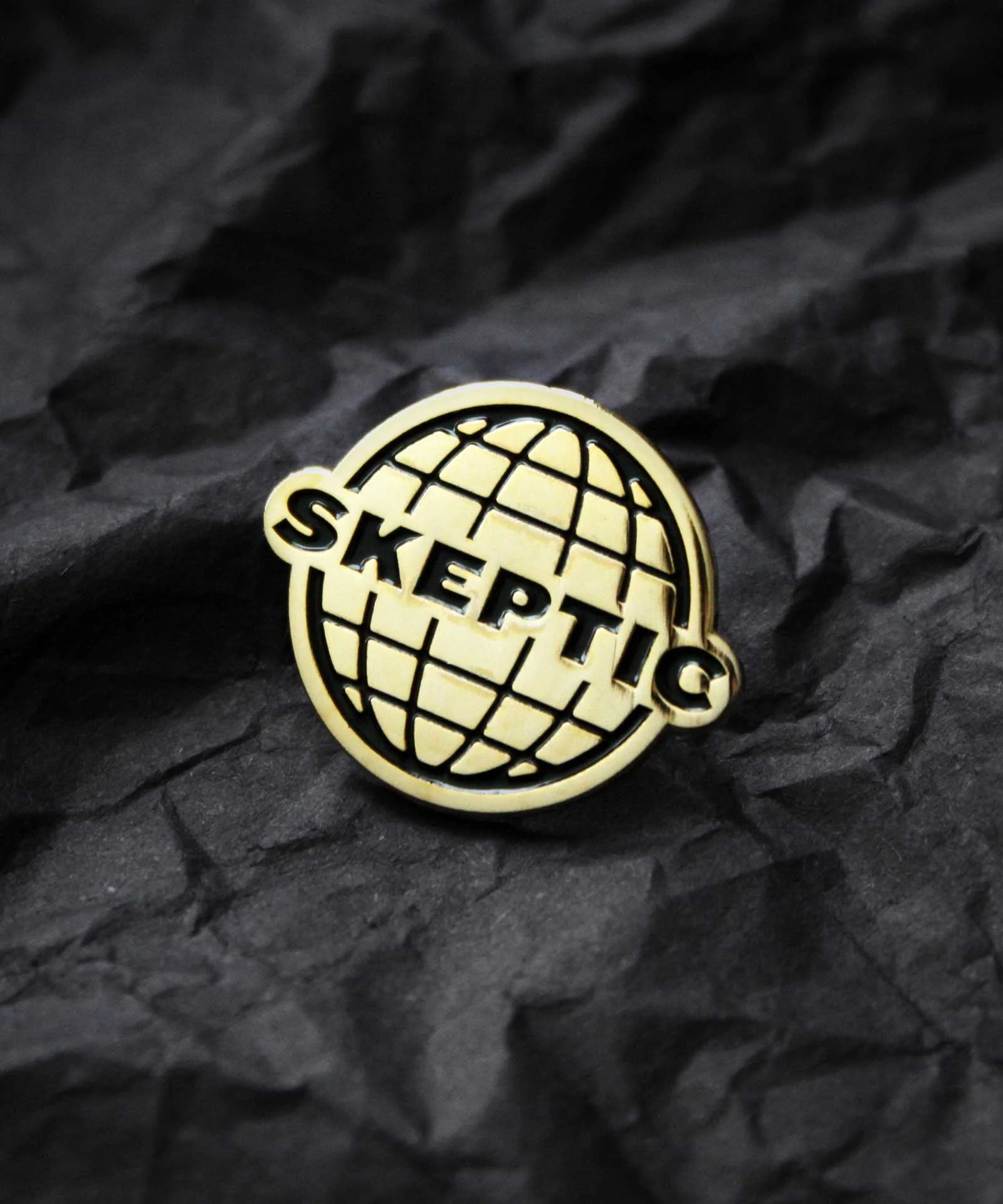 Product photography of gold enamel pin