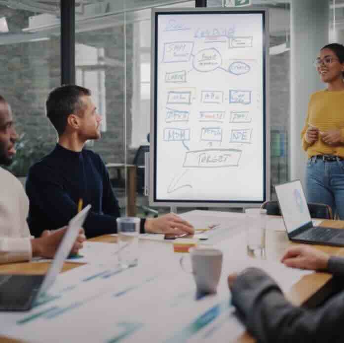 Project managers looking at screen with notes