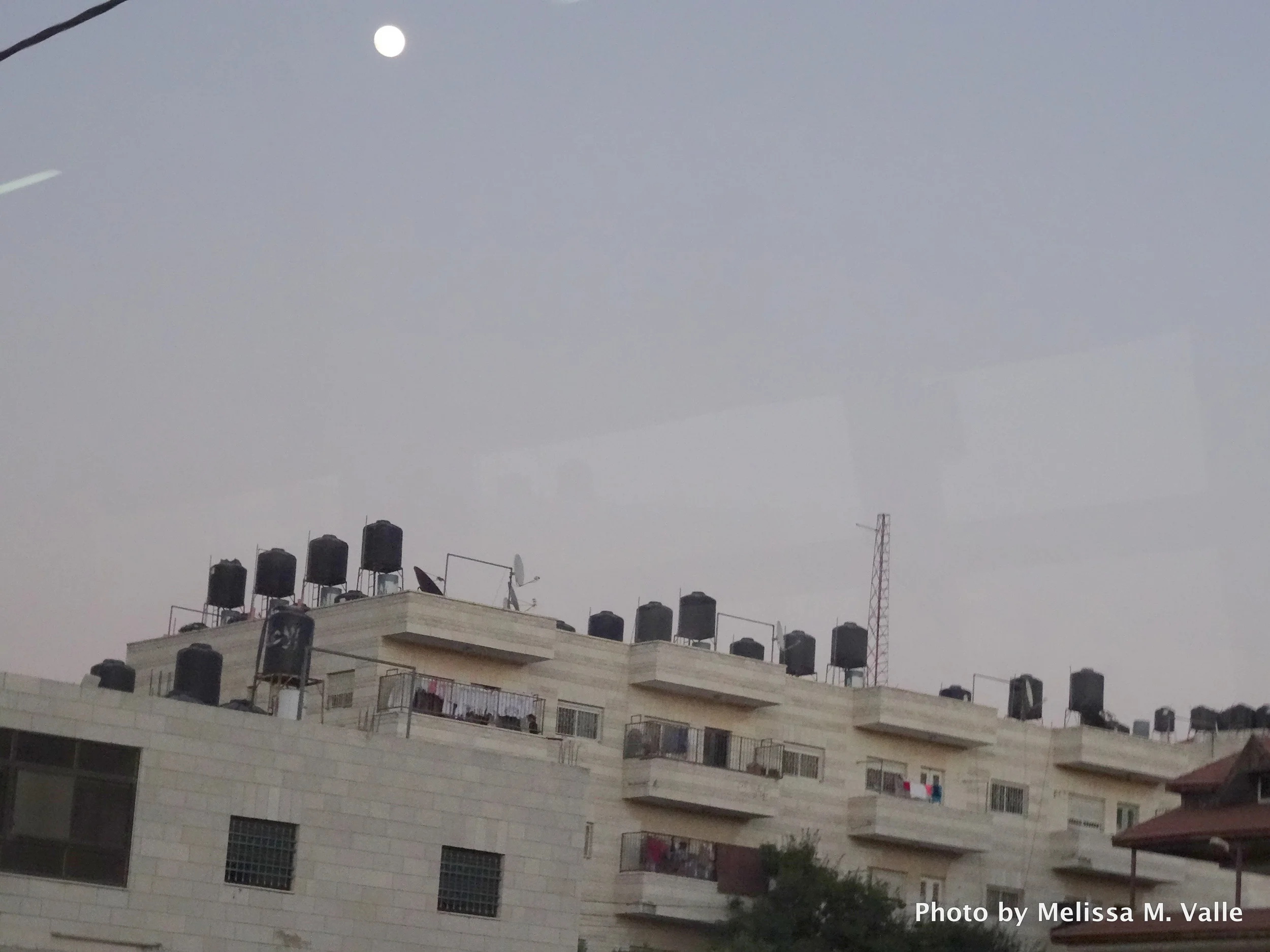 Water cisterns atop roofs in Palestine