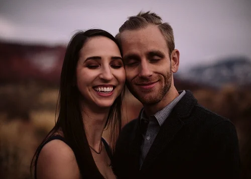 Couple smiling at their engagement shoot in Castle Valley, Utah
