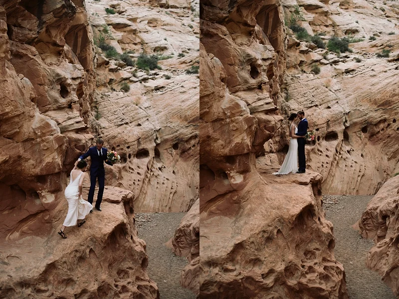 Couple climbs up rocks near Moab Utah