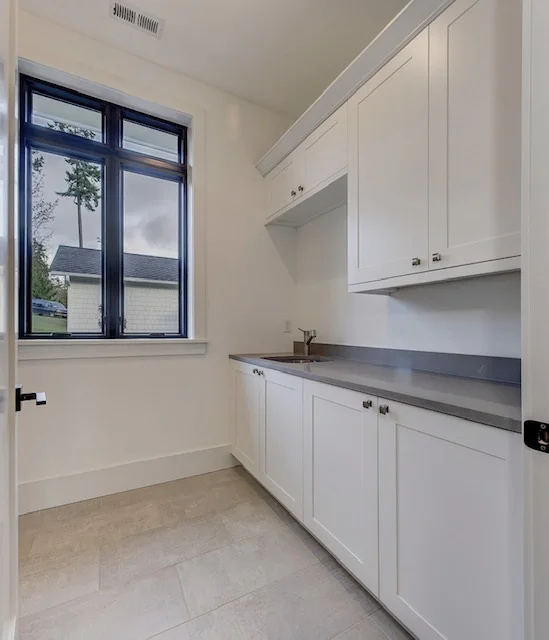 The laundry room includes plenty of storage for a busy family.