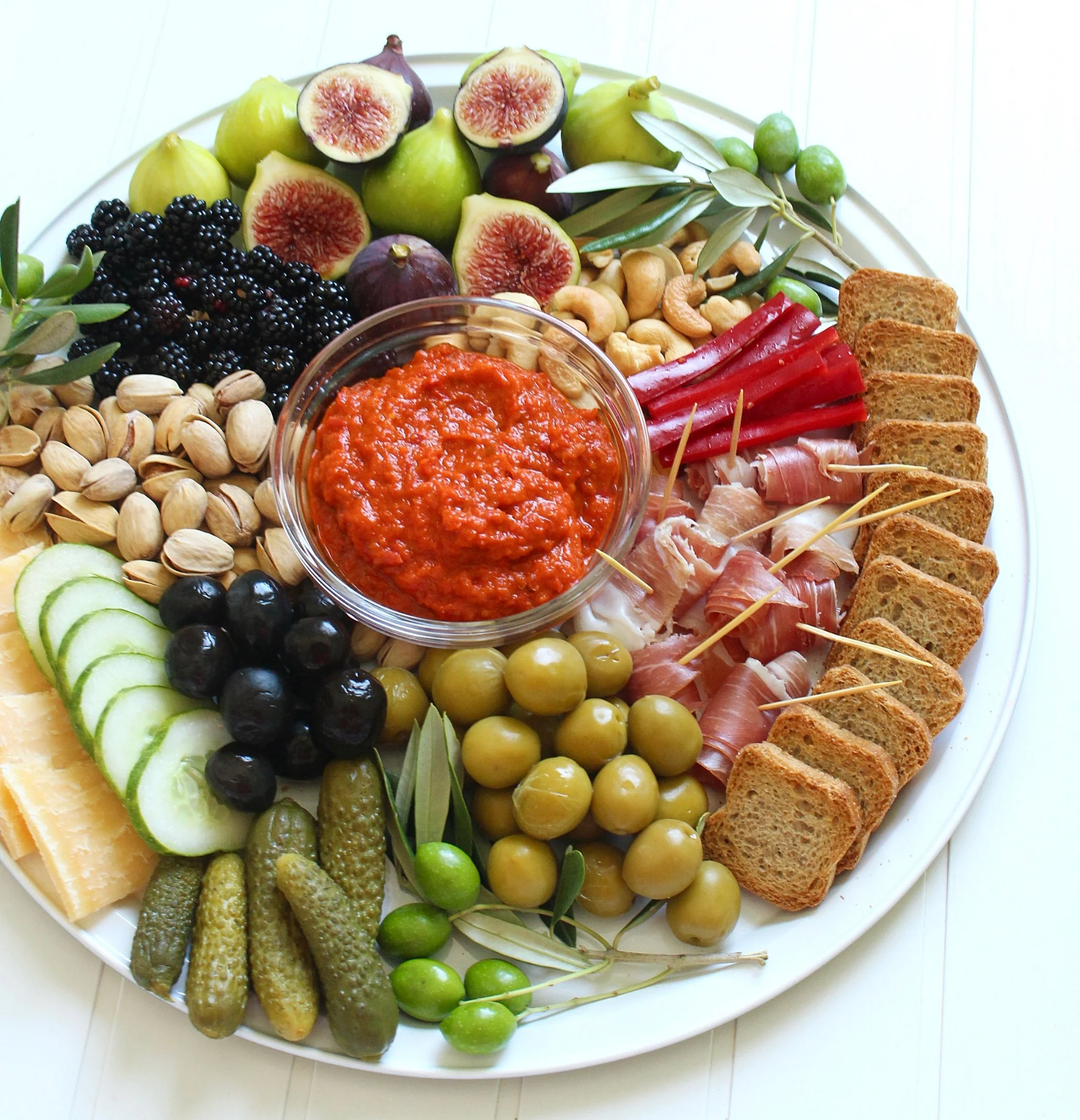 Lunch time platter Croatian styles! Roadside figs and blackberries, green and black olives, pungent cheese, rolled prosciutto, gherkins, fresh veggies, biscotti, nuts and ajvar - a super popular pepper-based condiment here.