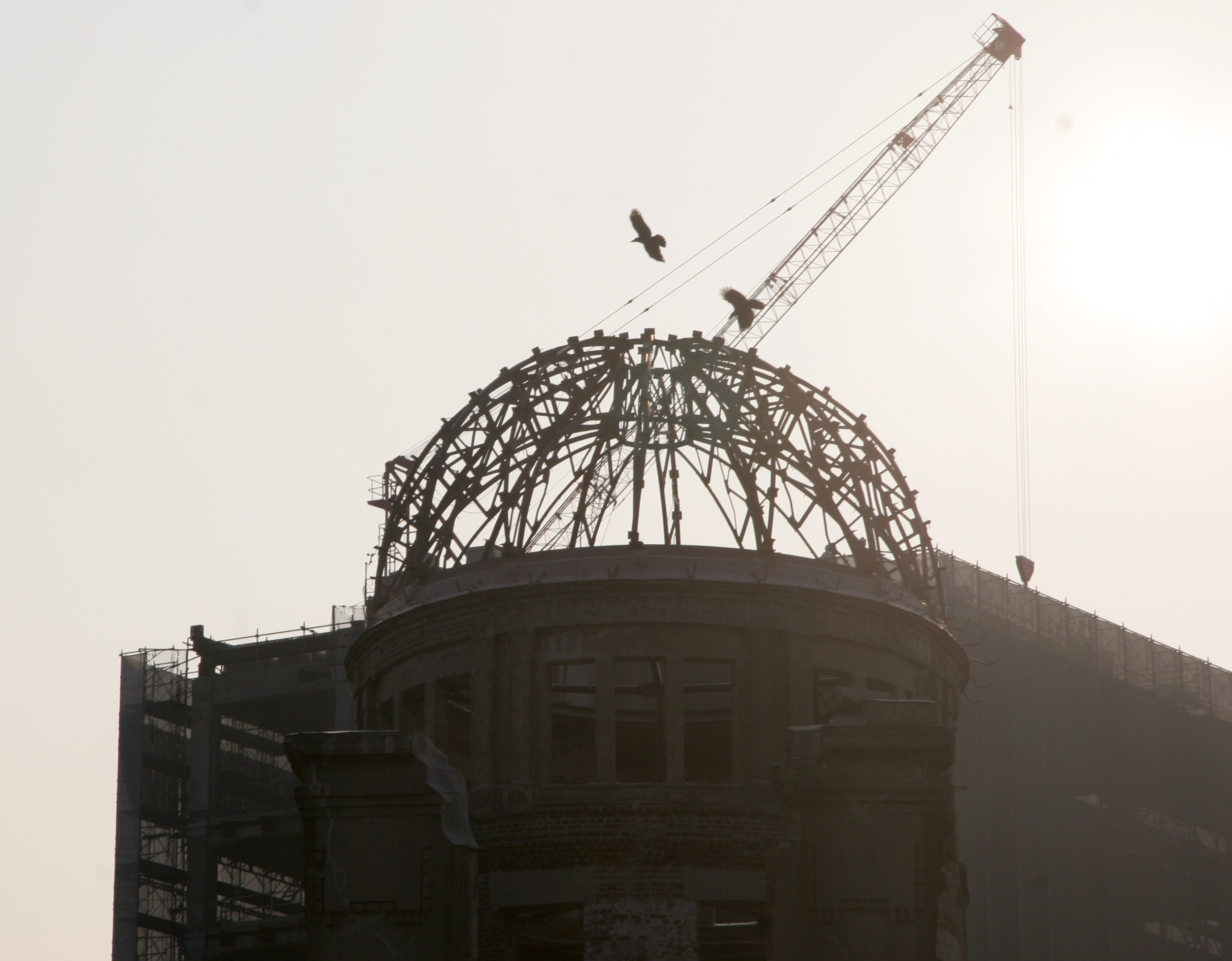 Birds greet the A-Bomb dome under the early morning sun