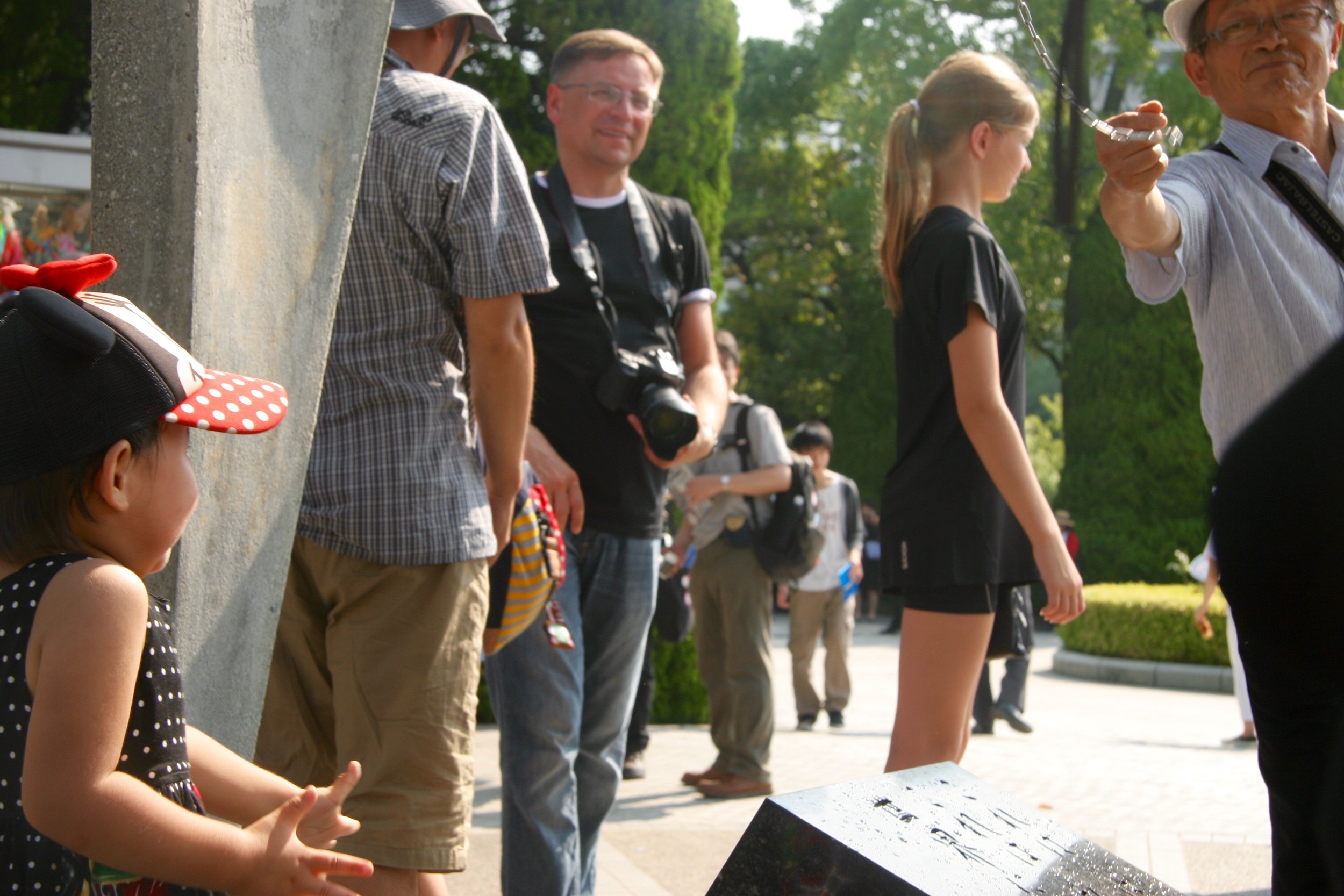 A young girl waits her turn to ring the peace bell at the children's memorial