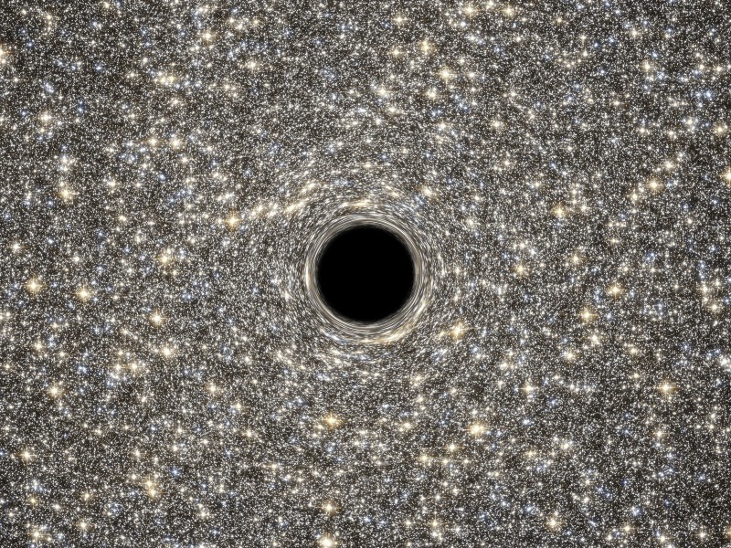 NASA Goddard — illustration of a supermassive black hole, weighing as much as 21 million suns, located in the middle of the ultradense galaxy M60-UCD1.