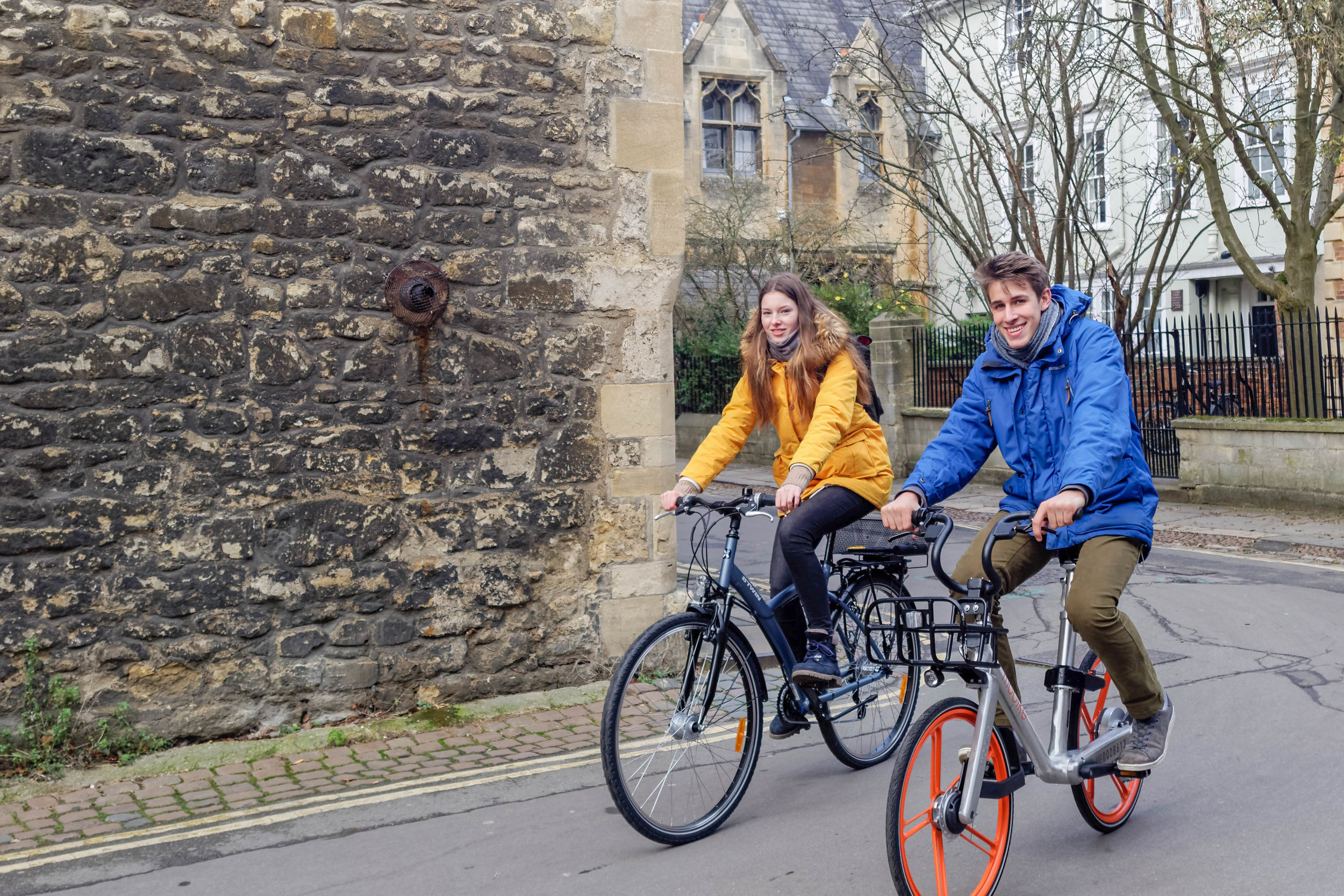 Anja and Max cycling down Queens Lane in Oxford city centre.