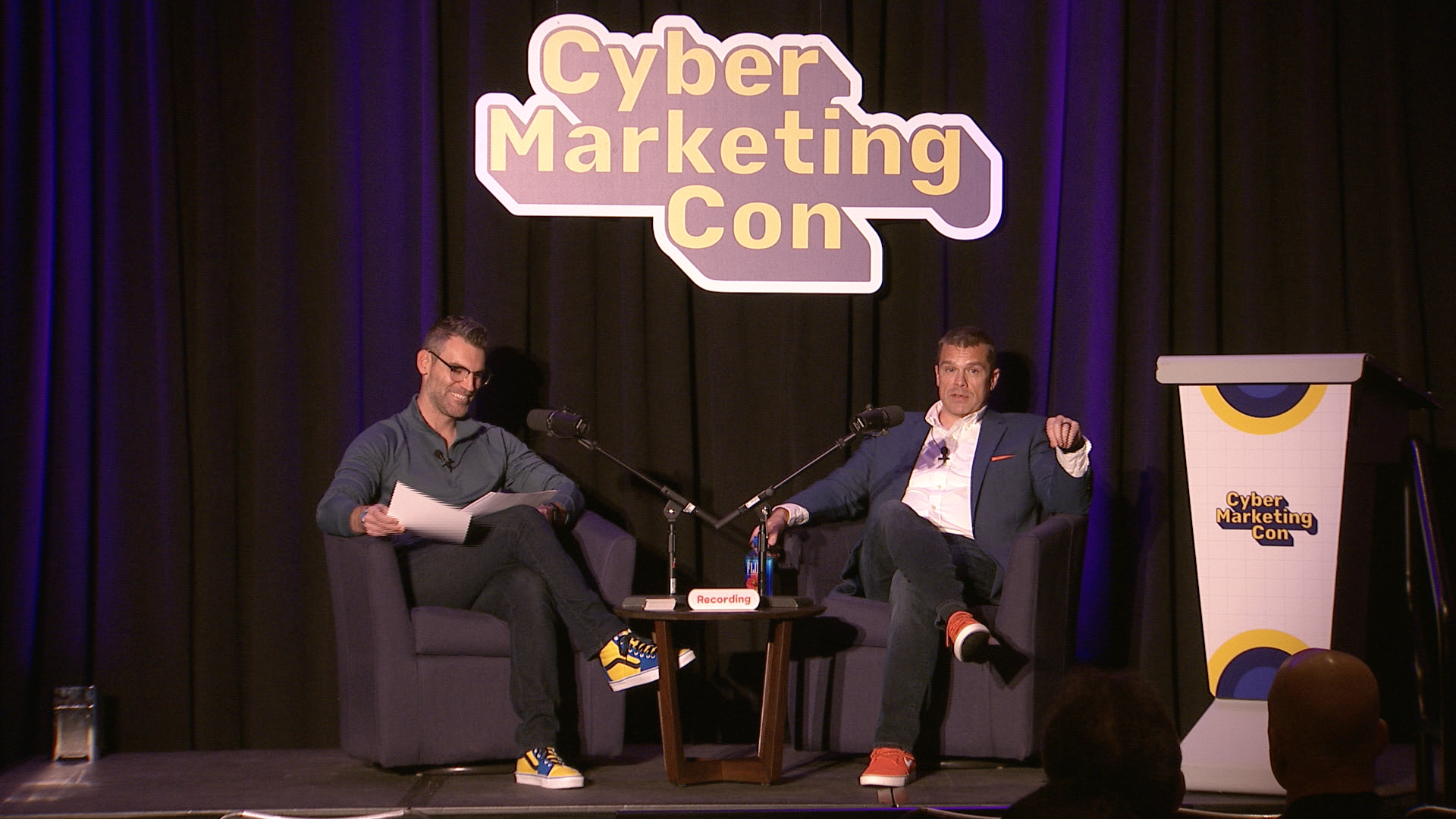 David J Ebner and David Moulton at Cyber Marketing Con 2024 discussing the Threat Vector podcast on stage.