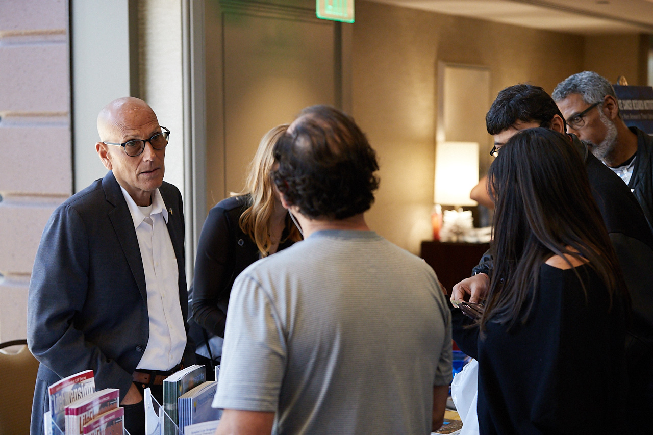 PCRI Helpline Facilitator Johnathan Levy at the PCRI Table answering questions and distributing educational materials