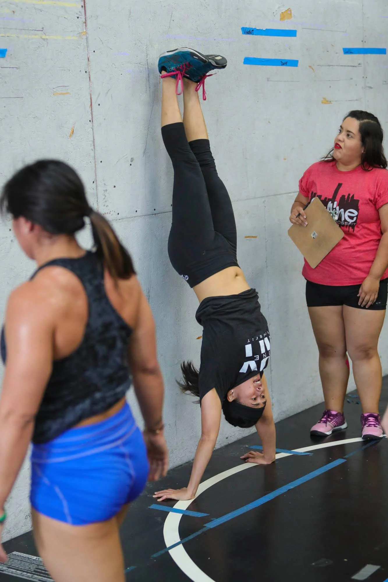 Coach Terri showing a good lockout in the handstand pushup.