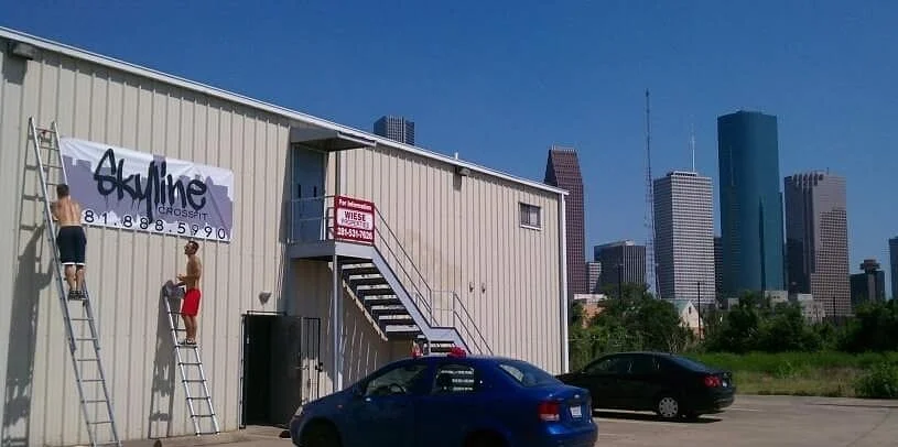 The owners of Skyline CrossFit hanging the banner on the newly leased building in May 2011. We started in a 1500 sq ft. building and have grown into our 7000 sq ft. build we currently use today.